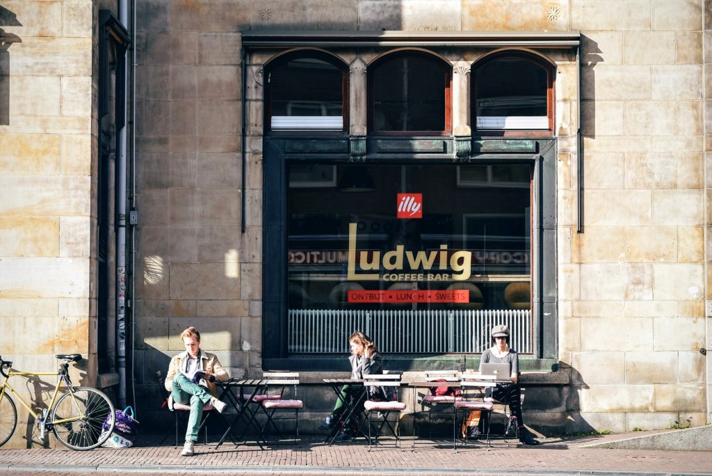 people working outside a coffee shop