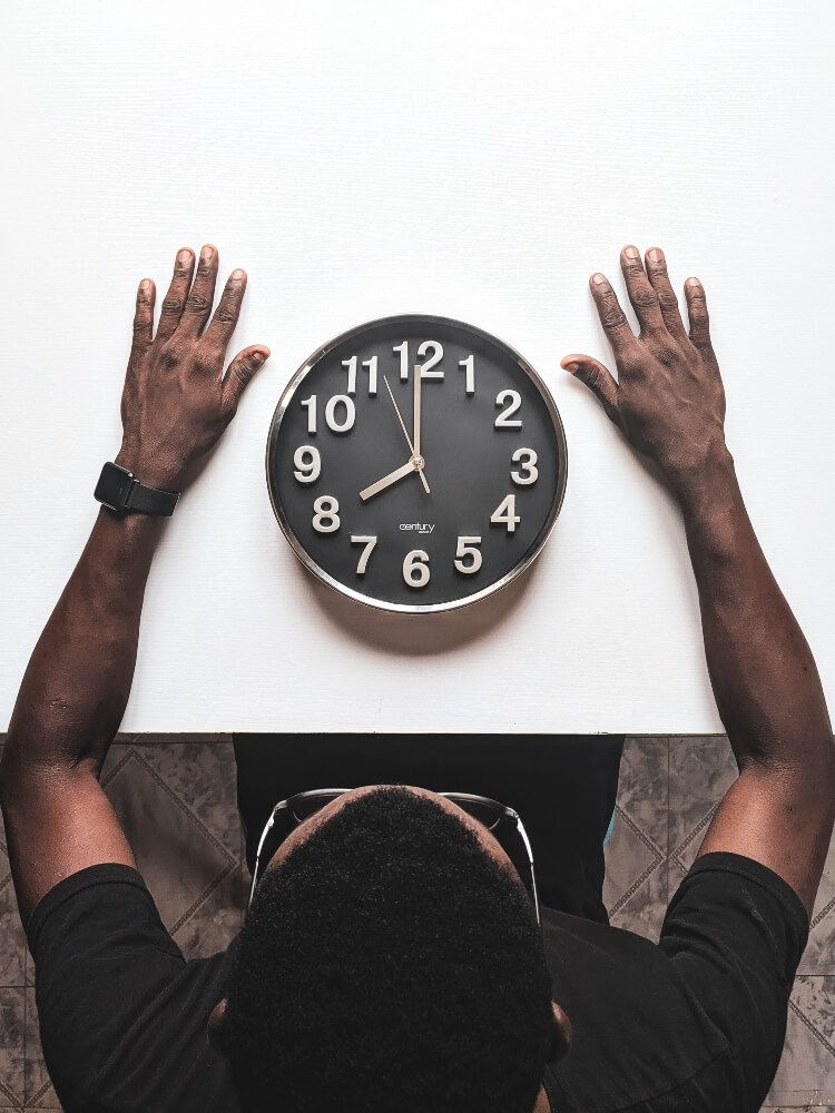 A person looking at the time on a clock