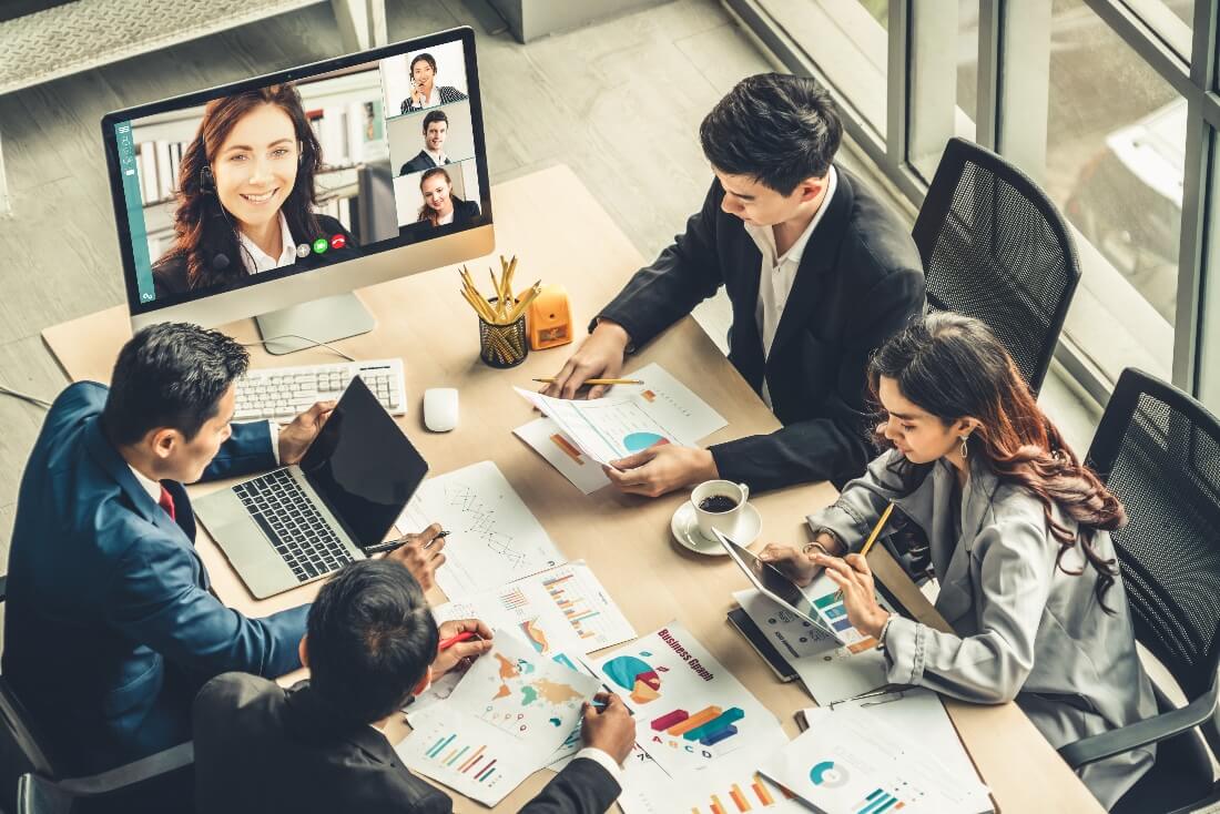 People working in the office with remote workers on a video call