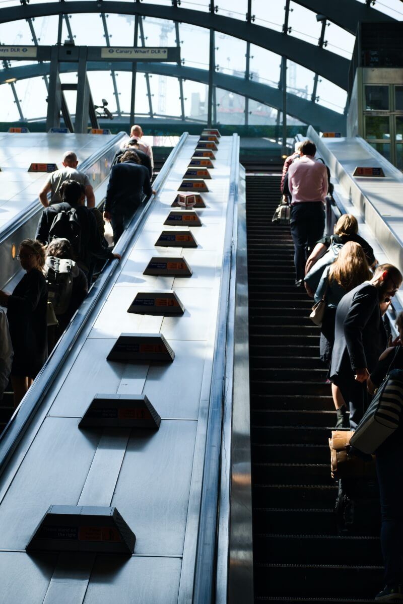 commutters exiting canary wharf station