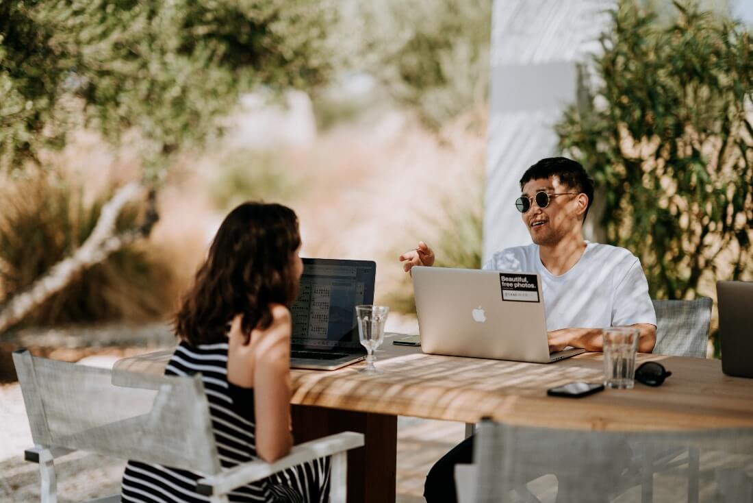 two people working remotely outside