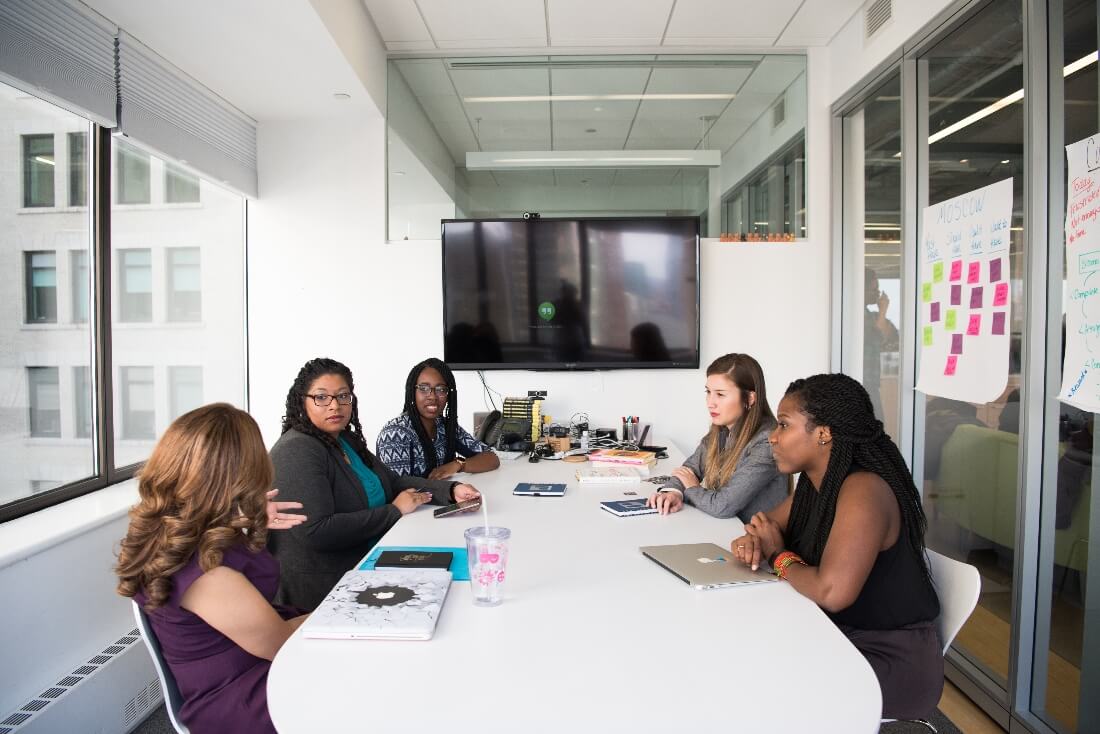 People in a hybrid meeting room with enough space